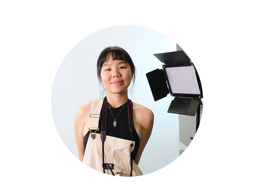 Portrait of Wenxin Zhao wearing overalls against a white background